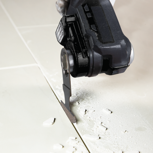 Makita XMT04ZB Action Shot (removing grout) - Thumbnail